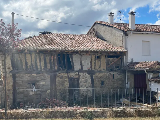 Tejado de teja árabe ya retejado en una casa de piedra